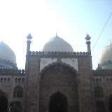 An imposing double storeyed gate-way with 4 recessed archways and 9 imposing cusped multifoiled openings in the main prayer hall.
