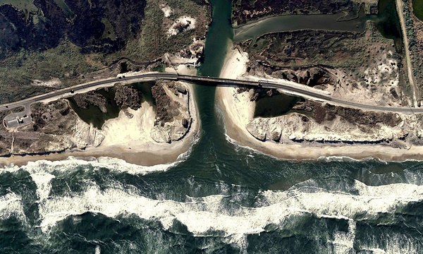 BESIEGED: Waves hit a new bridge on Highway 12 at Pea Island, N.C., over an inlet created by Hurricane Irene. Critics say officials should adopt a ferry system instead. North Carolina Department of Transportation