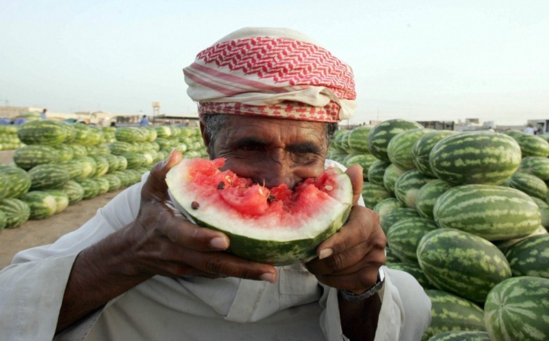 A Saudi man eats watermelon at the bazaar in Dhahran, 400kms east of the capital Riyadh on May 16, 2008. AFP PHOTO/STR (Photo credit should read -/AFP/Getty Images)