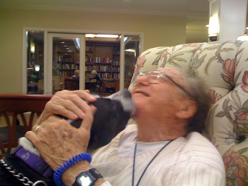 Don Meyer receiving lots of love from a visiting pooch!