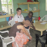 Julian our translator showing Luis how to bend over for his scoliosis check