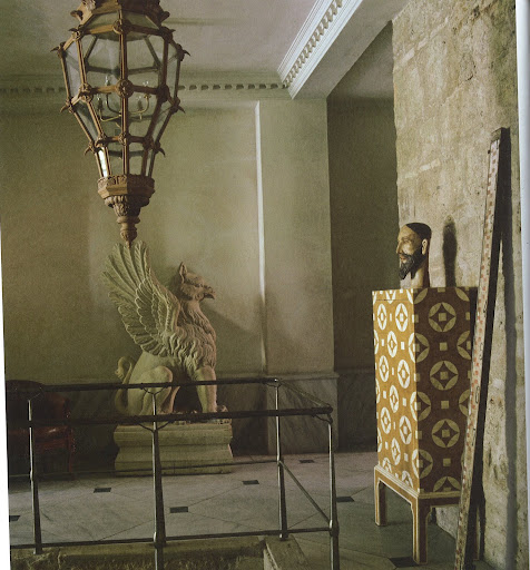 At Asli Tunca's home in Istanbul, a sandstone sculpture of a griffin and a Byzantine-inspired cabinet are on the landing. Atop the cabinet is a sixteenth-century saint's head from Goa, India. (Dealer's Choice, Architecture/Interiors Press, Inc.)