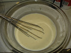 Whisk together egg yolks, milk, and cream before adding to the dry ingredients in the saucepan.