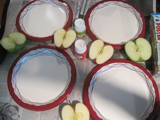 We set up newspaper to protect the countertop, and used paper plates for both dipping in paint and wiping away excess paint on the apples. We set up newspaper to protect the countertop, and used paper plates for both dipping in paint and wiping away excess paint on the apples.