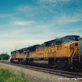 Union Pacific 8003 (EMD SD40-2H) is one of two units leading eastbound coal train crossing about to cross Burlington Northern track west of Fremont, Nebraska. August 1999