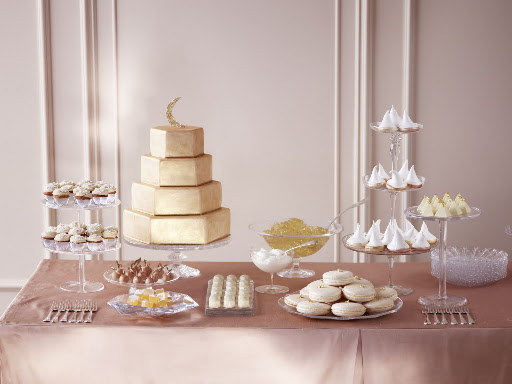 Standing tall over this dessert bar is a golden cake covered in fondant and brushed with luster dust. (Martha Stewart Weddings)
