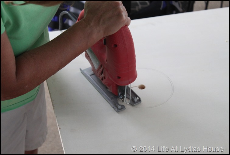 using a jig saw to cut the hole