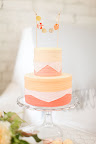 A pleated cake is topped with a small garland of its own.