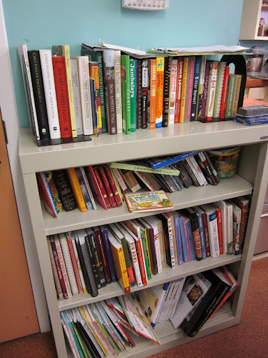 A case of cookbooks provides inspiration for new recipes and helps students learn about unfamiliar cuisines.