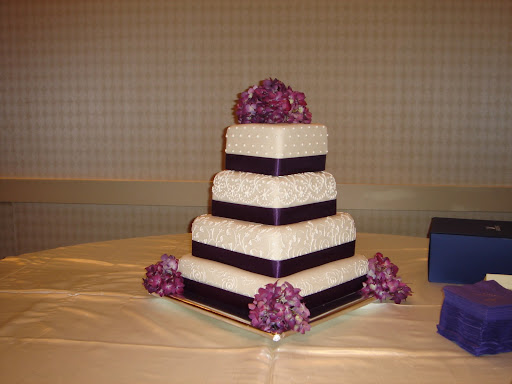 fondant wedding cake with scroll work purple ribbon and flowers 006jpg