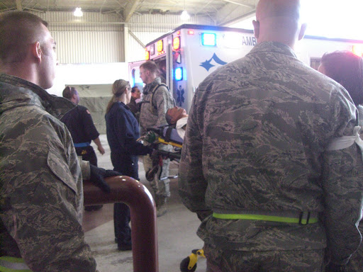 Military personnel stand by and wait to unload mock patients out of local ambulances. (Photo credit: Jennifer Moore)