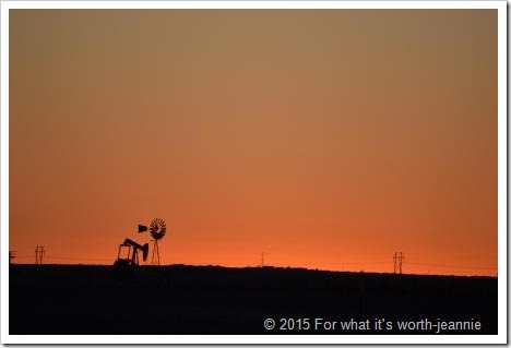 Texas cloudless sunset w oil well and windmill