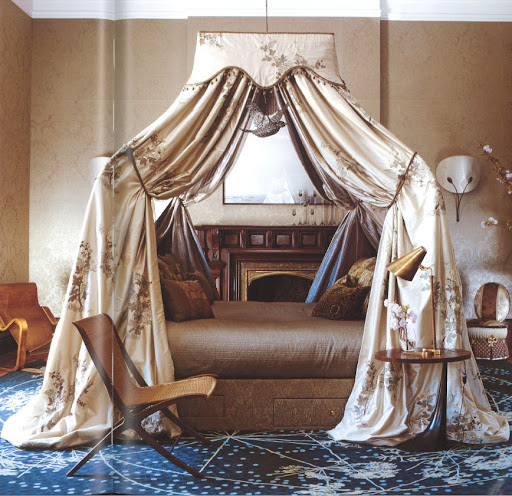 This floating bed occupies the center of the room with drama and elegance.  Rich textiles and a celestial rug push the artfulness even farther.