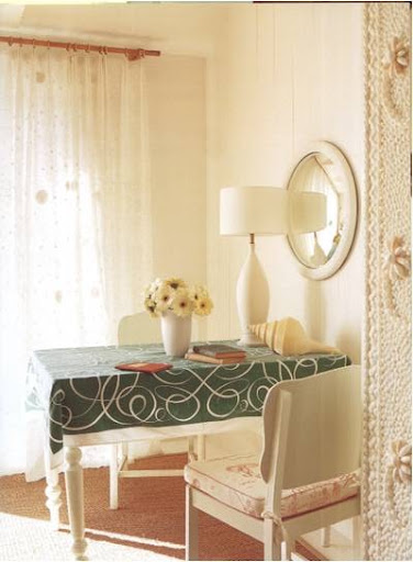 The door frame to the right is festooned with a mosaic of seashells.  I'd love to get my hands on the table linens, as well.