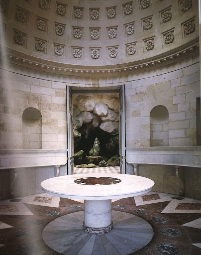 Louis XVI commissioned the painter Hubert Robert to oversee the creation of this pleasure diary for Marie Antoinette at Rambouillet. Drawing heavily upon ancient Greek precedents, the interior was further complimented with Neoclassical furniture designed by Robert himself. The circular table and colored marble floor were both added by Napoleon. (Regency Redux, Rizzoli) Louis XVI commissioned the painter Hubert Robert to oversee the creation of this pleasure diary for Marie Antoinette at Rambouillet. Drawing heavily upon ancient Greek precedents, the interior was further complimented with Neoclassical furniture designed by Robert himself. The circular table and colored marble floor were both added by Napoleon. (Regency Redux, Rizzoli)