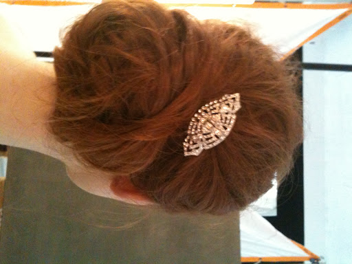 Using only the middle section of the model's hair, Sadah created a low bun. Then, she spiraled the loose strands around it for extra texture and dimension.
