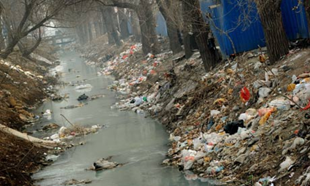 Rubbish and pollution blight a canal on the outskirts of Beijing. The average Beijinger has a footprint three times the Chinese average, says WWF. Mark Ralston / AFP / Getty Images