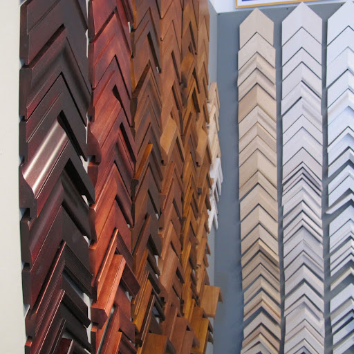 The frames are stuck on the wall using velcro. Customers can easily take down and try out potential frames.