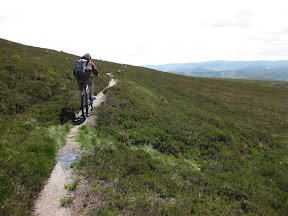 after reaching the top of the mountain, we're starting our descent.  we're tired (more from pushing than biking) but getting on the saddle again with these trails and this view is worth it.