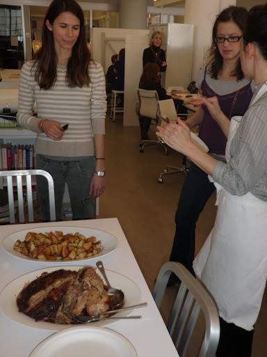 Deputy food editor Shira Bocar (far right) telling editor in chief Alex Postman and senior editor Terri Trespicio how she prepared the pork with a rub of toasted fennel seeds and fresh herbs.