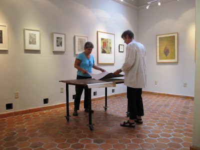 Debra and Liz look at his portfolio