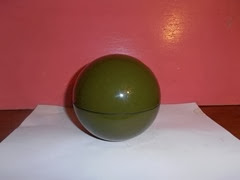 Olive green plastic storage ball with a black interior by ATC