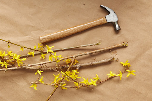 To make a color block arrangement, you need to cut floral foam to fit snugly inside the vessel you're using. Cut the branches to the desired height and remove any buds from their bottoms to the top vessel. Pound the base of each branch with a hammer to splinter it, allowing it to easily take up water. Begin inserting branches tightly in the foam, working from the center outward. Trim branches as you would a hedge. To make a color block arrangement, you need to cut floral foam to fit snugly inside the vessel you're using. Cut the branches to the desired height and remove any buds from their bottoms to the top vessel. Pound the base of each branch with a hammer to splinter it, allowing it to easily take up water. Begin inserting branches tightly in the foam, working from the center outward. Trim branches as you would a hedge.
