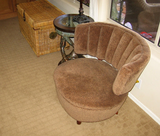 Lynda found this barrel chair in the trash at her grandmother's apartment complex. It was originally covered in an ugly green fabric so she simply recovered it with new fabric and voila!