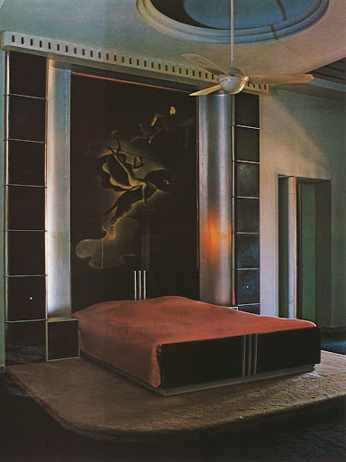 And in complete contrast, the guest room has a chrome- banded bed in the style of Ruhlmann that rests on a platform. Hmmm... And in complete contrast, the guest room has a chrome- banded bed in the style of Ruhlmann that rests on a platform. Hmmm...