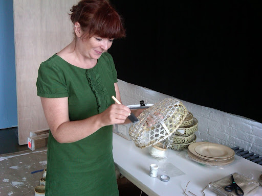 Jo, from The Green Vase, paints a basket for the wall hanging.