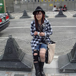 Japanese girl sitting on a chain fence on Jingu bridge in Harajuku, Japan 