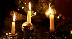 c0 Christmas candles burning with a background of pine branches