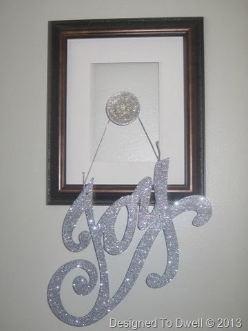 Joy Ornament on Coat Hook