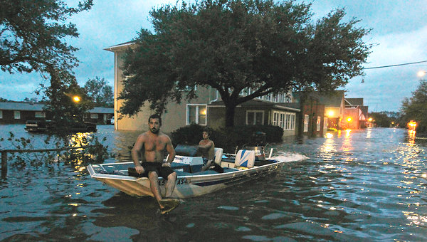 Manteo, N.C., residents navigate streets that were flooded by Hurricane Irene in August 2011. Rising tides are likely to mean more frequent coastal flooding. John Bazemore / Associated Press