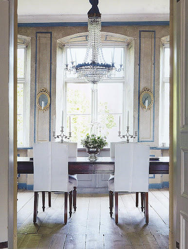 Tailored white slipcovers in an exquisite 1770s Swedish dining room.