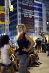 Long day. Protesters surrounded the Expo into the evening. SIgn at rear is from water workers, discussing how the water supply of Thessaloniki has been sold to a private, for-profit company.