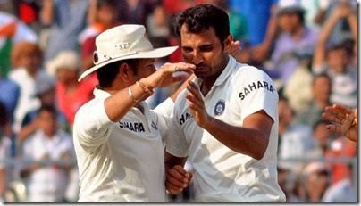 Indian cricketers Sachin Tendulkar and Mohammed Shami celebrate after fall of a wicket during the 1st day of the 1st test match between India and West Indies at Eden Gardens, Kolkata on Nov. 6, 2013. (Photo: IANS)