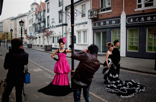 Chinese newlyweds pose for wedding photographs near to the Thames Town Church in Thames Town on 19 November 2010 in Songjiang, China. Daniel Berehulak / Getty Images file