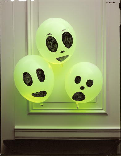 Glowing balloons with goulish faces make quick and easy decorations. (www.marthastewart.com)