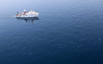 A National Oceanic and Atmospheric Administration vessel cruises past blobs of oil bubbling up near the Deepwater Horizon wellhead on Aug. 30, 2011. Federal officials said they have collected samples but have been unable to pinpoint the source. Samples collected by the newspaper came from the BP well, according to chemical analysis by LSU scientists. Terese Collins and On Wings of Care