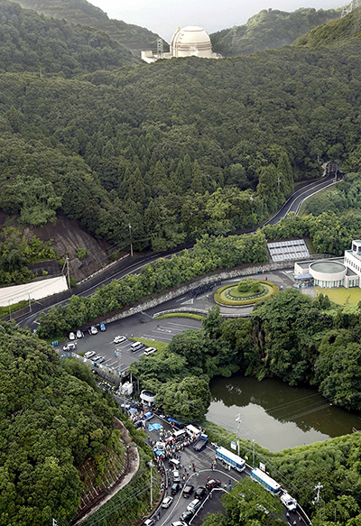 Aerial view of people protesting the restart of Ohi nuclear power plant block a road leading to the entrance, 2 July 2012. AP via guardian.co.uk