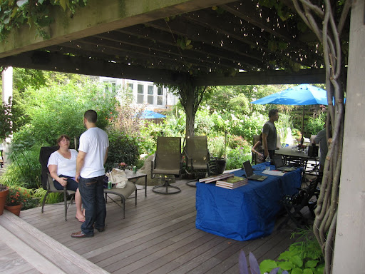 The deck has a pergola with lush grapevines covering the top. Here, Rick and his crew and putting the finishing touches on the space before the guests arrive.