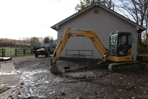 All right, boys, we need to dig a trench here to lay pipes for water!  Then we can install a hose inside the hoop house for easy watering.