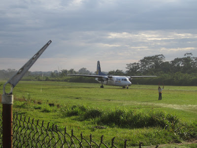 And here comes our flight! Look its not so rural, there's even the ping-pong bat guy to direct the plane in.