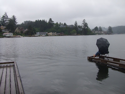 A Lone Fisherman Fishes in the Rain