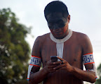 An indigenous man sends a text message to the tribe about the occupation