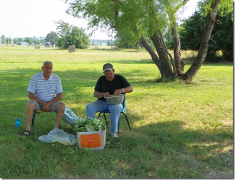 Don & Dennis, shucking corn, getting ready to feed the masses