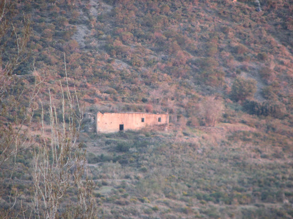 Abandoned farmhouse across the gulch