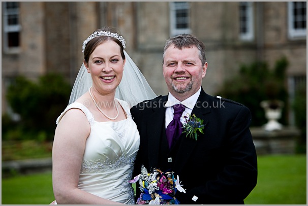 a smiling bride and groom in scotland