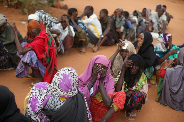 Somalian refugees wait at the entrance to the registration area of the IFO refugee camp, which makes up part of the giant Dadaab refugee settlement on July 24, 2011 in Dadaab, Kenya. The ongoing civil war in Somalia and the worst drought to affect the Horn of Africa in six decades has resulted in an estimated 12 million people whose lives are threatened. Oli Scarff/Getty Images
